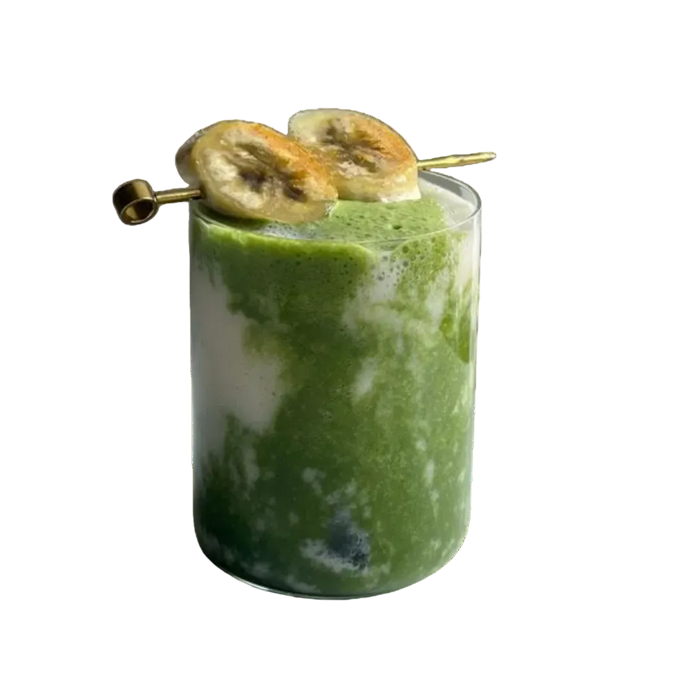 Banana bread matcha in a glass with banana slices on a white background